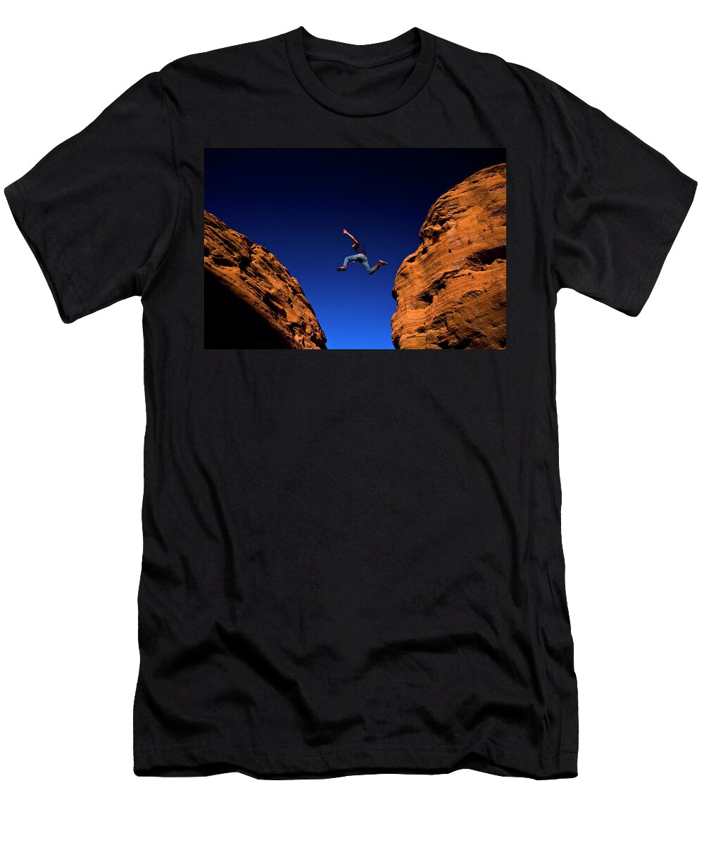 A Man Jumps Across a Chasm While Hiking Kirk Mastin T-Shirt