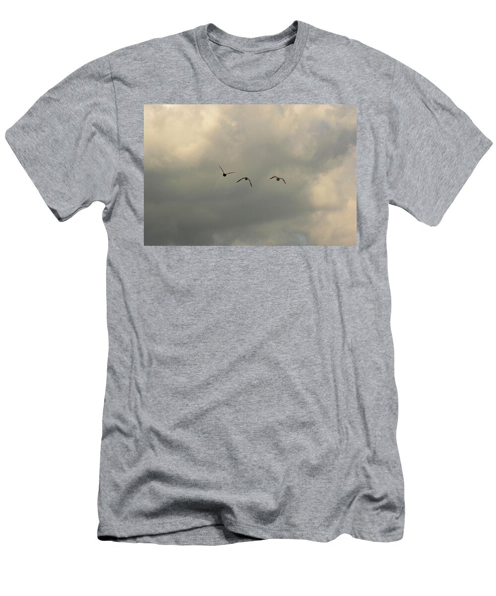 Three Birds Flying Against Stormy Grey Clouds Johan Ferret T-Shirt