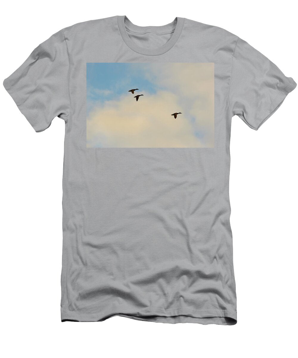 Three Ducks Flying Against a Cloudy Blue Sky Johan Ferret T-Shirt